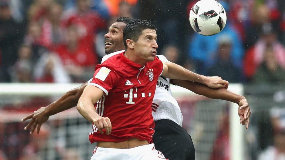 MUNICH, GERMANY - SEPTEMBER 17: Robert Lewandowski (R) of Muenchen battles for the ball with Marvin Matip of Ingolstadt during the Bundesliga match between Bayern Muenchen and FC Ingolstadt 04 at Allianz Arena on September 17, 2016 in Munich, Germany.
